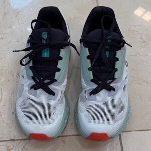 On Running White and Green Athletic Shoes